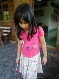 Cute girl standing on floor at home