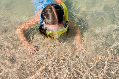 High angle view of girl snorkeling at shore