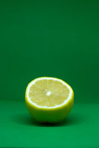 Close-up of lemon slice over green background