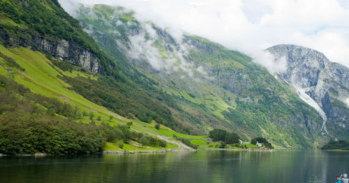 Scenic view of lake and mountains against sky