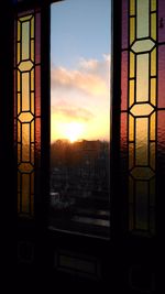 Close-up of window against sunset sky