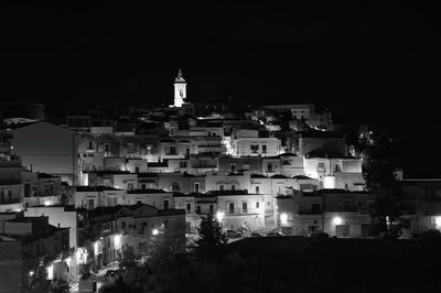 High angle view of illuminated buildings against clear sky at night