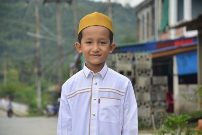 Portrait of smiling boy standing outdoors