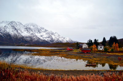 Low tide in the fjord with mountain view and houses on the bank