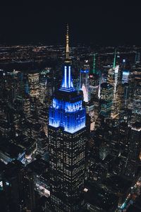 Illuminated cityscape against sky at night