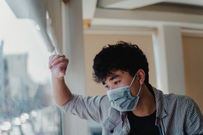 Close-up of man wearing mask standing outdoors