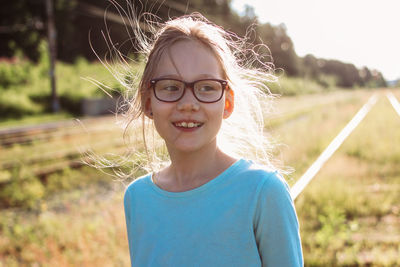 Smiling girl standing outdoors