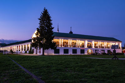 Built structure on field by building against sky at night