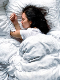 Young woman sleeping on bed