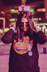 Portrait of smiling young woman standing outdoors