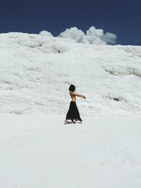 Full length of woman standing by railing