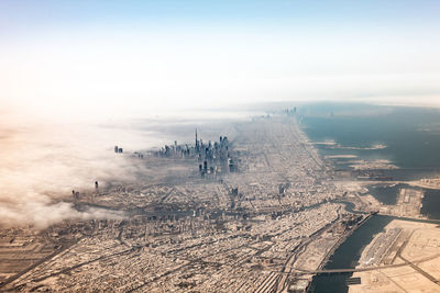 Aerial view of cityscape against sky