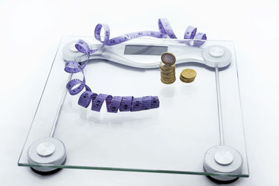 High angle view of eyeglasses on table against white background