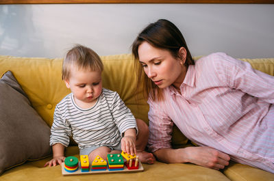 High angle view of mother playing with toys at home