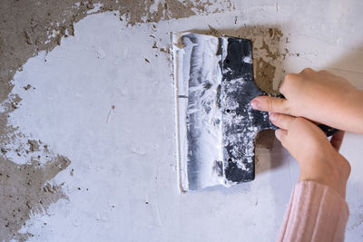 Low section of woman standing against wall