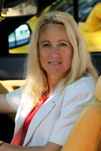 Portrait of beautiful woman sitting in car