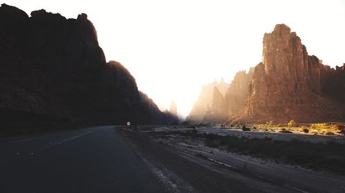 Road amidst rocks against clear sky