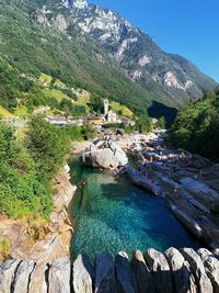 High angle view of river amidst rocks and buildings