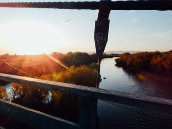 Scenic view of river against sky during sunset