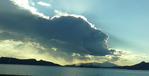 View of calm sea against mountain range