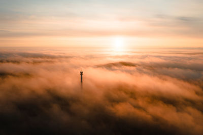 Low angle view of smoke stack against sky during sunset