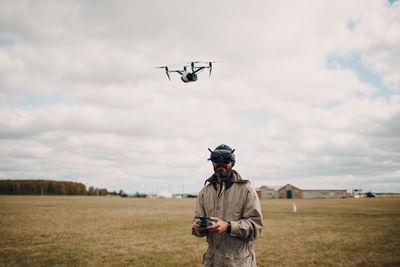 Man standing on field against sky