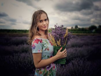 Portrait of smiling woman standing in field