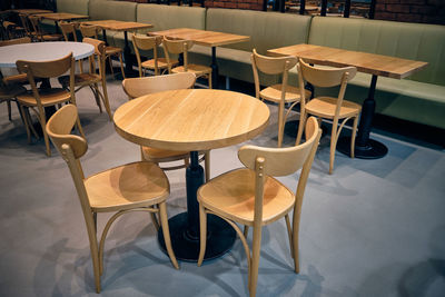 Wooden stools and wooden tables at cafe.