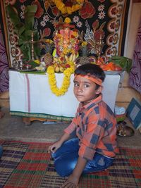 Portrait of boy sitting in traditional clothing