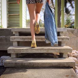 Low section of woman standing on tiled floor