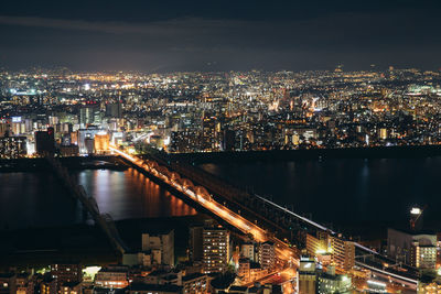 High angle view of illuminated buildings in city at night