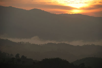 Scenic view of mountains against sky at sunset
