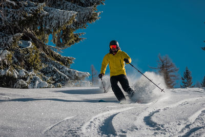 Man skiing on snow covered mountain