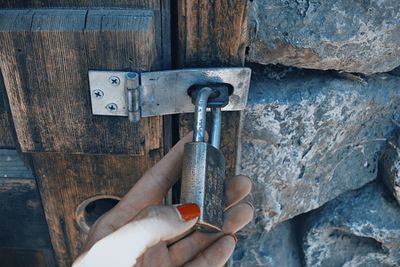 Cropped hand holding padlock