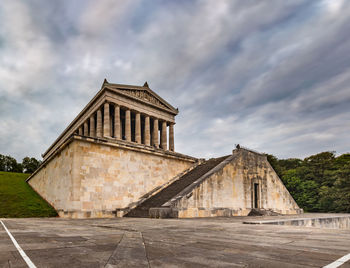 View of old building against cloudy sky