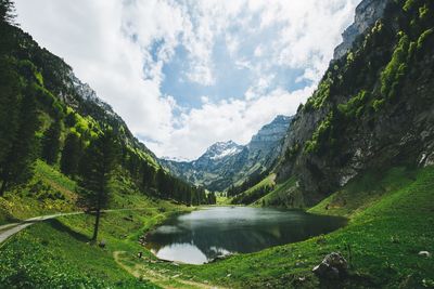 Scenic view of lake and mountains against sky