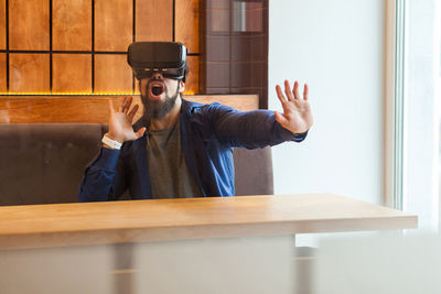 Portrait of man using laptop on table