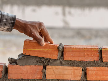 Man working on wood against sea