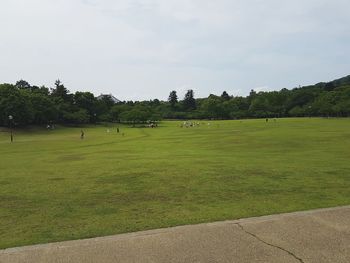 Scenic view of golf course against sky