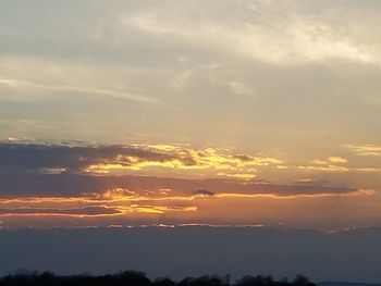 Scenic view of silhouette trees against sky at sunset