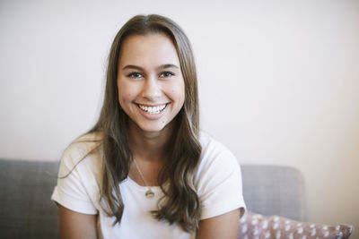 Portrait of smiling teenage girl sitting at community center