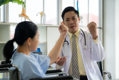 Portrait of doctor examining patient at clinic