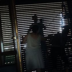 Midsection of woman standing on tiled floor