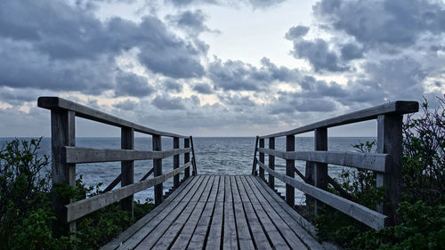 Pier over sea against sky