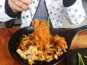 Midsection of man preparing food on table