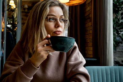 Portrait of young woman using mobile phone