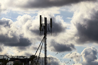Low angle view of communications tower against sky