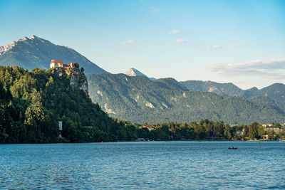 Scenic view of lake and mountains against sky