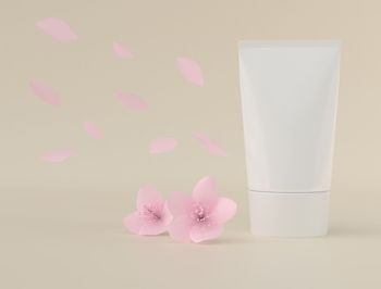 Close-up of pink rose on white table