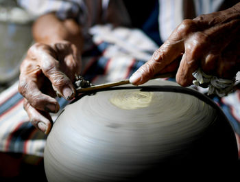 Midsection of man making pottery